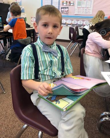 Pictured is a first grade boy wearing suspenders dressed up as 100 years old