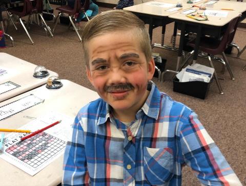 Pictured is a first grade boy dressed up as one hundredth days old.