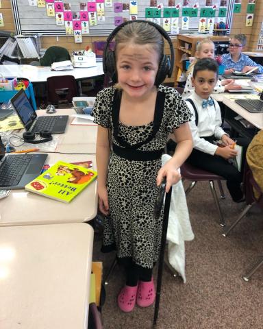Pictured our students dressed up as they have lived 100 days gray hair using canes and old dress attire