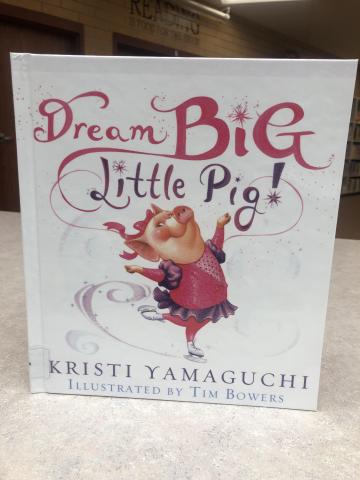 Pictured the the front cover of the book, with a pig skating in a pink outfit.