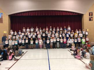 This picture was taken after our "Make Your Mark" assembly.  Eighty-four students and Mrs. Killian are lined up on the stage at Riverview Elementary.  All students are holding a certificate for working hard in school and being willing to enter into the learning pit.  These students used their learning powers, worked hard at learning something new, then was able to get out of the learning pit.  